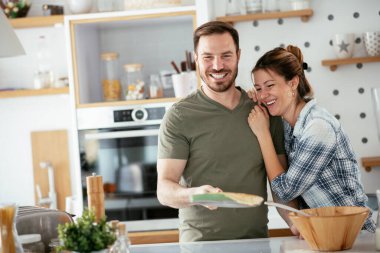 Genç çift evde krep yapıyor. Sevgili çift yemek yaparken eğleniyor..