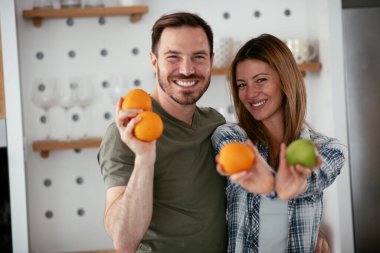 Mutfakta genç bir çift. Mutlu çift meyve salatası yapıyor..