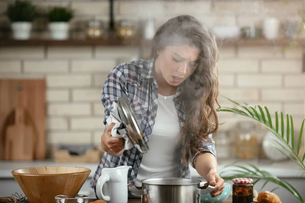 Young Woman Cooking in the kitchen. Woman cooking pasta dish.