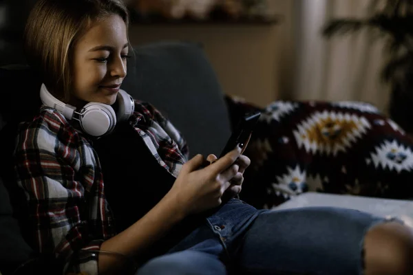 Close Photo Positive Little Girl Headphones Using Smartphone Home — Stock Photo, Image