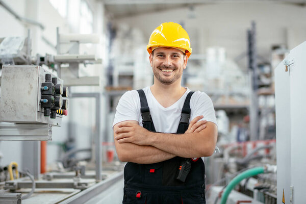 Portrait of factory worker. Young handsome factory worker.