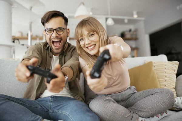 couple playing video games at home