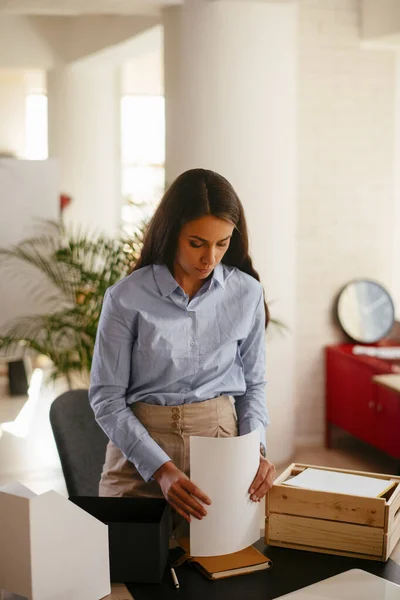 Young businesswoman organizing documents in the office