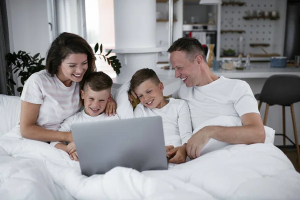 아름다운 부모와 아이들 집에서 즐기고 있습니다 노트북으로 영화를 — 스톡 사진