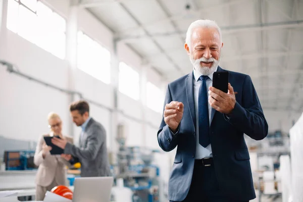 Telefon kullanan bir iş adamı. Fabrikada iş adamı..