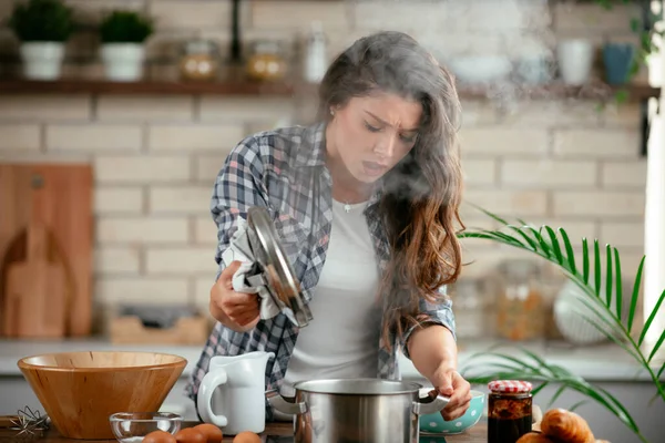 Young Woman Cooking in the kitchen. Woman cooking pasta dish.