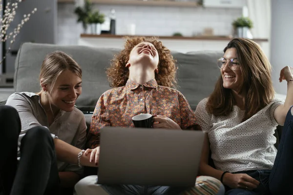 Happy businesswomen talking and laughing in office. Beautiful women on coffee break.