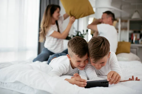 Happy family making pillow fight