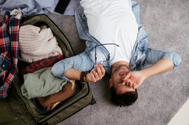 Adam yolculuğa hazırlanıyor, bavulunu hazırlıyor.