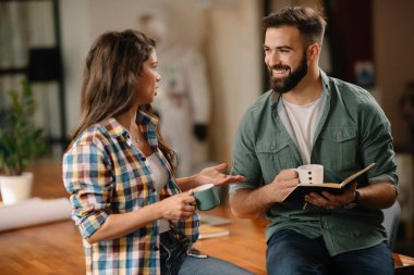 Tasarımcı, ortaklarına proje hakkında yeni fikirler veriyor. İş adamları ofiste yeni iş projelerini tartışıyor.