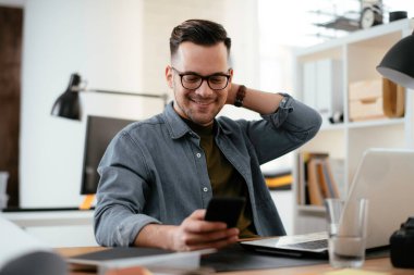 Genç işadamı ofiste çalışıyor. 