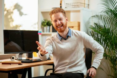 İşyerinde çalışan kızıl saçlı bir iş adamı.