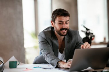 İş adamı proje üzerinde çalışıyor. Ofiste çalışan genç bir işadamı..