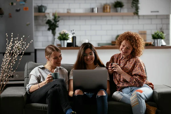 Happy businesswomen talking and laughing in office. Beautiful women on coffee break.