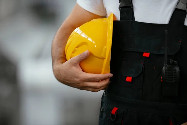 Close Worker Holding Yellow Helmet Stock Picture