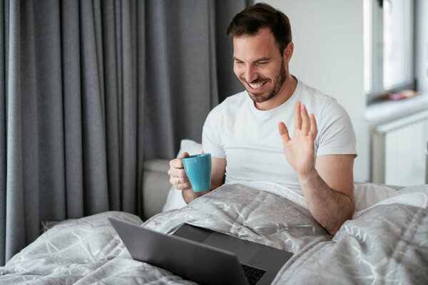 Young Man Watching Movie Bed Drinking Coffee Handsome Man Enjoying Stock Picture