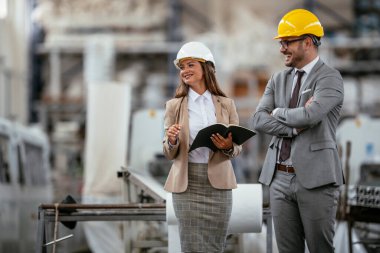 Erkek ve kadın iş tartışıyorlar. Fabrikada çalışan meslektaşlar.