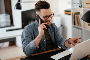 Genç işadamı ofiste çalışıyor..