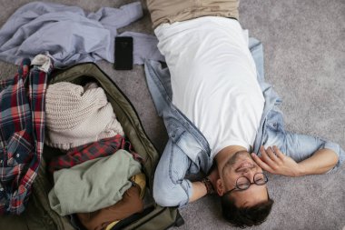 Adam yolculuğa hazırlanıyor, bavulunu hazırlıyor.