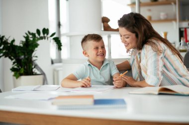 Anne oğluyla ödev yapıyor.