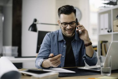 Genç işadamı ofiste çalışıyor..