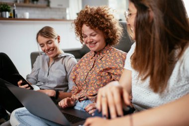 Ofiste kız arkadaşlar konuşuyor ve gülüyor. Ofiste kahve içen güzel kadınlar