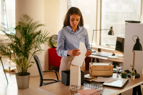 Young businesswoman organizing documents in the office