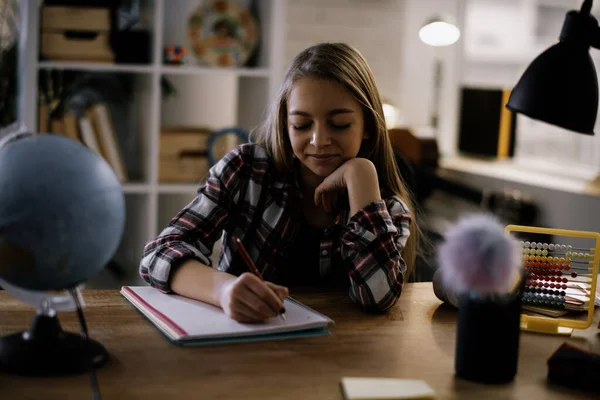 Cute little girl studying at home