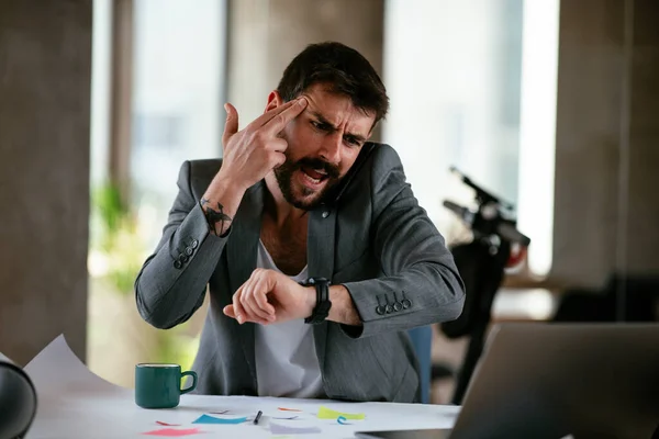 Angry businessman working on project. Young businessman working in the office.