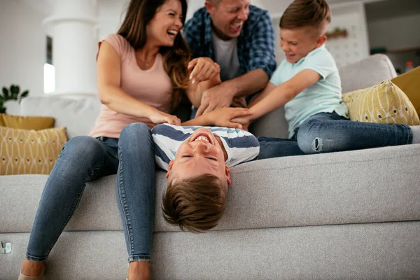 stock image Young family enjoying at home. Happy parents with sons having fun.