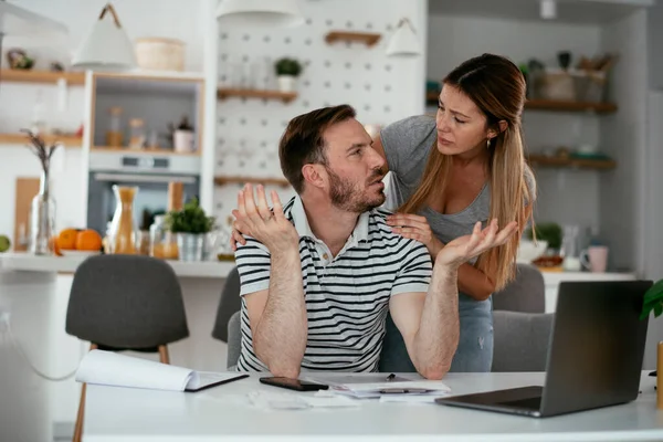 Husband and wife preparing bills to pay. Young couple having financial problems