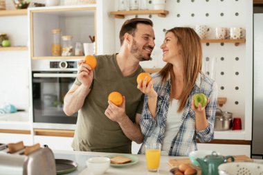 Mutfakta taze meyveleri olan mutlu çift.