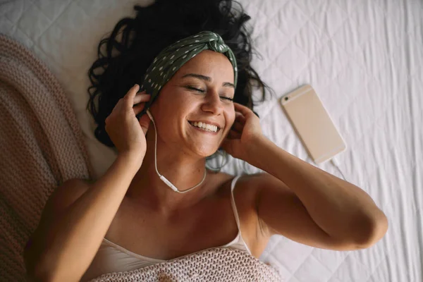 Жінка Ліжку Слухає Музику Красива Дівчина Лежить Ліжку Навушниками — стокове фото