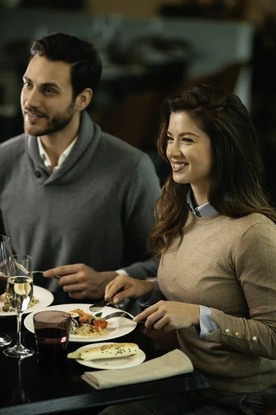 Happy loving couple enjoying in restaurant. Young couple enjoying in food.