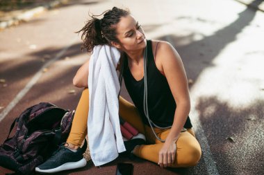 Genç bir kadın dışarıda egzersiz yapıyor.  