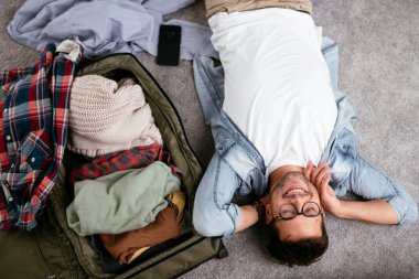 Adam yolculuğa hazırlanıyor, bavulunu hazırlıyor.