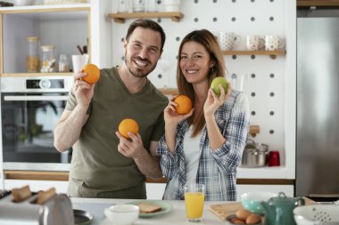Mutfakta taze meyveleri olan mutlu çift.