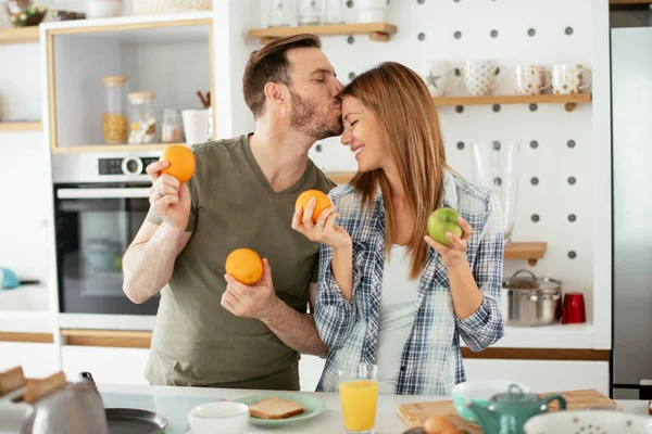 Mutfakta taze meyveleri olan mutlu çift.