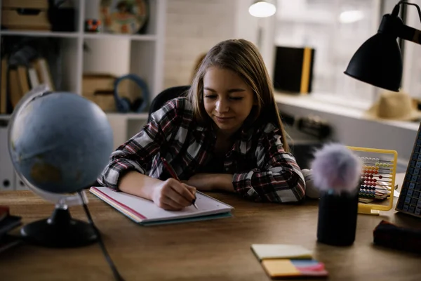 Cute little girl studying at home