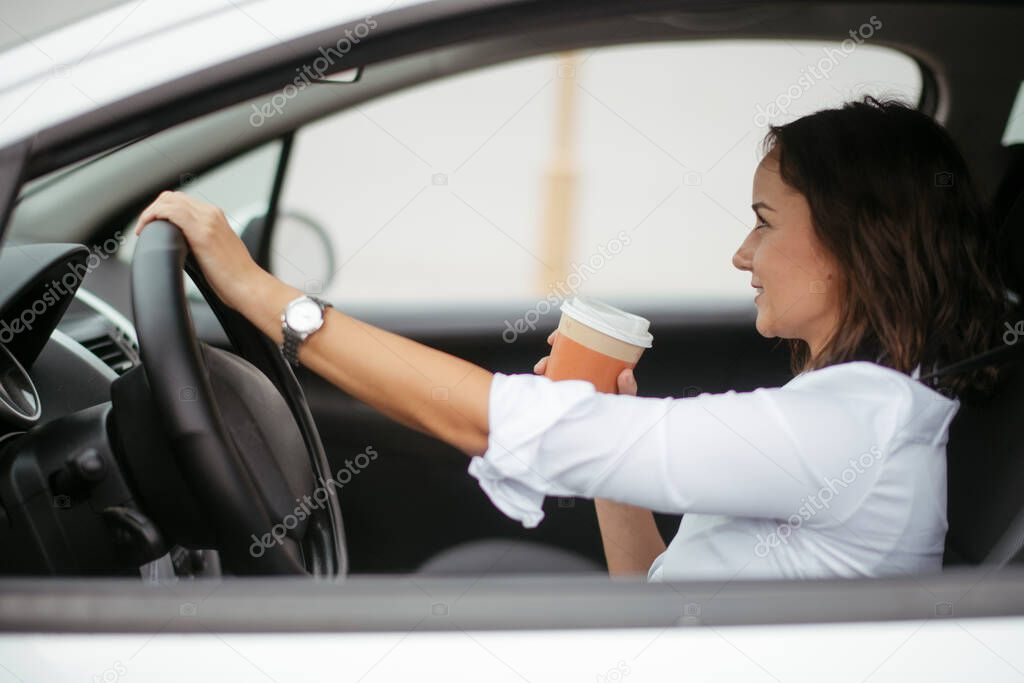 Young woman in car. Businesswoman driving car.