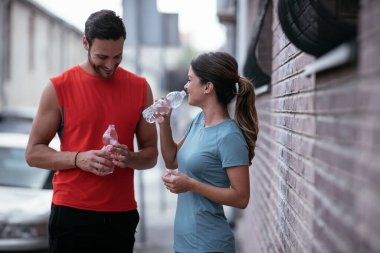 Atletik çift şehirde koştuktan sonra dinleniyor. Mutlu çift sabahları eğleniyor...