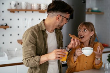 Mutlu çift evde kahvaltı yapıyor.