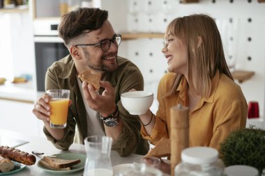 Mutlu çift evde kahvaltı yapıyor.