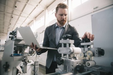 Fabrika müdürü imalat teftişinde. Endüstriyel çevredeki adam