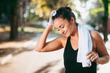 Genç bir kadın dışarıda egzersiz yapıyor. 