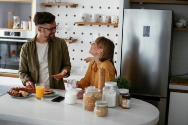 Mutlu çift evde kahvaltı yapıyor.