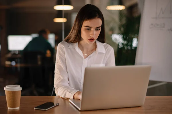 woman working in office at night