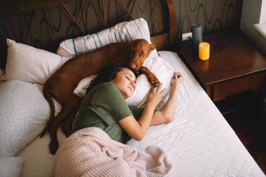 Güzel bir kadının köpeğiyle yatakta uyuduğu en iyi manzara.