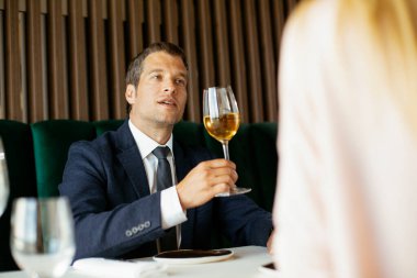 Şarap içen yakışıklı bir iş adamı. İş adamı restoranda eğleniyor.