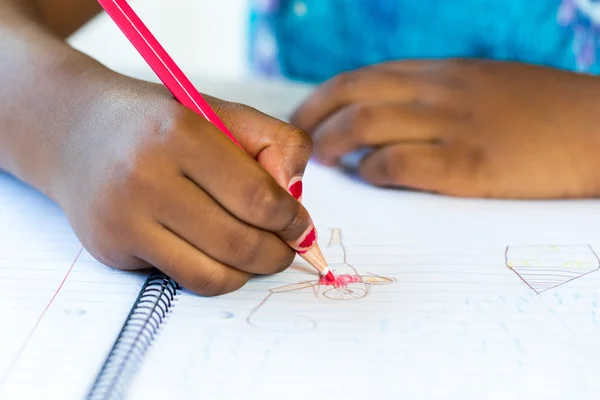 Afrikaanse kid's hand tekenen op papier. — Stockfoto